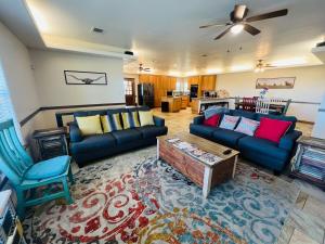 a living room with two couches and a table at Hilltop Bastrop Retreat in Bastrop