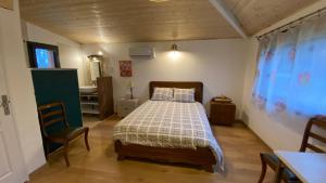 a bedroom with a bed and a table and chairs at Chambre Lucioles in Orniac