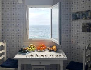 a table with a bowl of fruit in front of a window at Ocean Whisper suite in Tacoronte +18 photos
