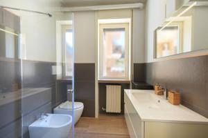 a bathroom with a toilet and a sink at La Casa Del Tasso in Feriolo +13 photos