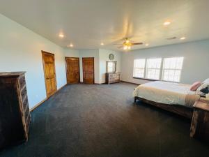 a large bedroom with a bed and a ceiling fan at Hilltop Bastrop Retreat in Bastrop