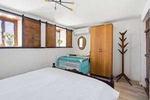 a bedroom with a white bed and a window at Villa Kokoshi, an extraordinary experience. in Berat