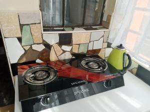 a stove top oven sitting on top of a counter at Rymach homes in Eldoret