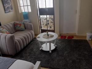 a living room with a couch and a table at Rymach homes in Eldoret