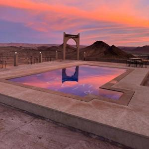 a swimming pool in the middle of the desert at Riad Belvedere in Ouzina