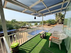 a balcony with a view of a swimming pool at Kp's Riverland Resorts in Madwa
