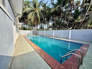 a swimming pool with a bench next to a building at Kp's Riverland Resorts in Madwa