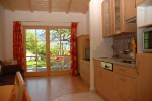 a kitchen with a sliding glass door to a patio at Eichmannhof in Marlengo +54 photos