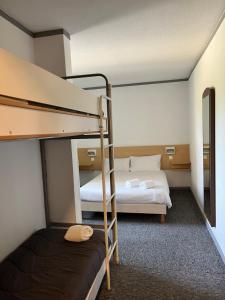 a room with two bunk beds and a mirror at FastHotel Montpellier Ouest - Un Hôtel FH Classic in Saint-Jean-de-Védas