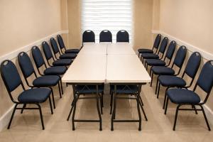 a conference room with a white table and chairs at Swan Rio Grande in Rio Grande