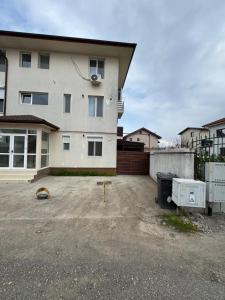 a parking lot in front of a house at Apartament Yuk in Bragadiru