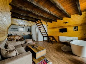 a living room with a couch and a wooden ceiling at Chill inn kazbegi in Kazbegi