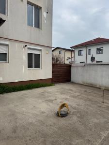 a object in a parking lot next to a building at Apartament Yuk in Bragadiru +5 photos