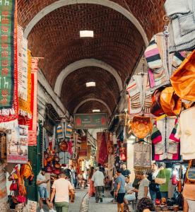 a group of people walking through an indoor market at Dar Haroun Tunis in Tunis