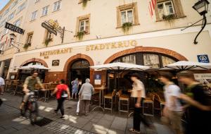 a group of people walking in front of a building at Altstadt Hotel Stadtkrug in Salzburg