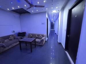 a hallway with couches and a table in a room at The Redcarmine in New Delhi