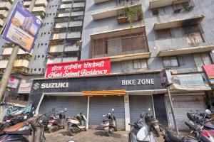a group of motorcycles parked in front of a building at Hotel Saineel Residency in Mumbai