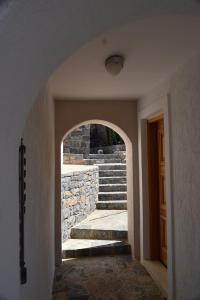 an archway in a hallway with a stone staircase at Olous Secret Hideaway - Sea View Studio Elounda in Elounda +3 photos
