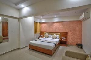a bedroom with a large bed in a room at Hotel Saineel Residency in Mumbai
