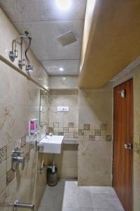 a bathroom with a sink and a shower at Hotel Saineel Residency in Mumbai