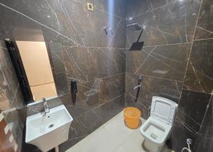 a bathroom with a sink and a toilet at The Redcarmine in New Delhi