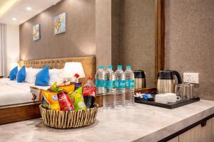 a hotel room with a counter with bottles of water at OPO Horizon Aerocity ,Delhi Airport in Jāmb +23 photos