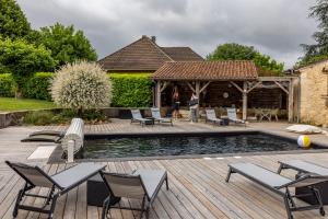 a backyard with a pool and chairs and a gazebo at Ô Délices de la Monnerie in Bourgnac +7 photos