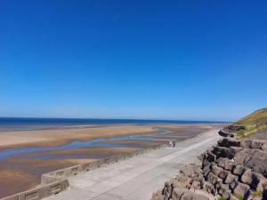 a person walking along a walkway near the beach at Cavendish Cat and Gaming House in Blackpool