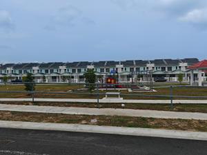a row of houses with a park in the foreground at Homestay Amna DShorea in Port Dickson