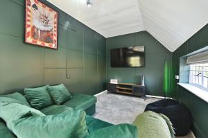 a living room with a couch and a tv at Blackham Farm in Hartfield