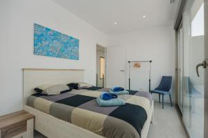 a bedroom with a bed and a blue chair at Villa Sophia in Busot +36 photos