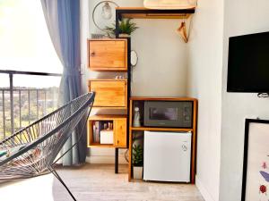 a living room with a tv and a small refrigerator at maisonde ojolac in Kosŏng-ni