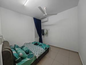 a room with a couch and a ceiling fan at Homestay Amna DShorea in Port Dickson +9 photos