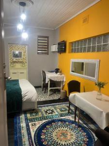 a room with two beds and a table in it at Muco Guest House in Johannesburg