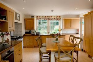a kitchen with a table and chairs and a window at Binsness house in Findhorn