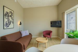 a living room with a couch and a chair at Aalborg Hotel Apartments in Aalborg +53 photos