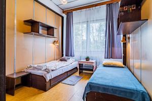 a bedroom with two beds and a window at Hotel Garni in Liptovský Mikuláš