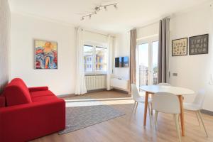 a living room with a red couch and a table at Lexia Suite in Lesa