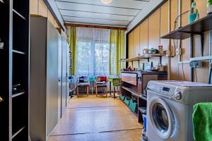 a laundry room with a washing machine and a table at Hotel Garni in Liptovský Mikuláš
