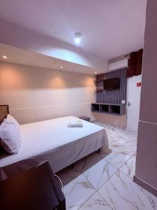 a bedroom with a large bed in a room at Hotel Nações Unidas in São Paulo