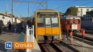 a yellow train on the tracks at a train station at Coastal & Connected Summer Resort Parking in Cronulla