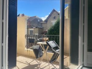 a view of a balcony with a table and chairs at Le Sam in Brive-la-Gaillarde