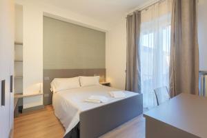 a bedroom with a white bed and a window at Lexia Suite in Lesa