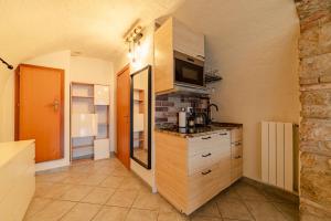 a kitchen with a sink and a microwave at Studio with private garden by GardaDoma in Brenzone sul Garda +10 photos