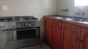 a kitchen with a stove and a sink at FRANCHISE BENONI GUEST HOUSE in Benoni