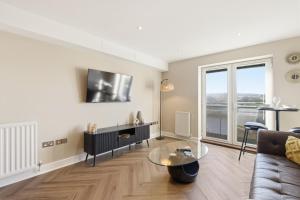 a living room with a couch and a table at High Quays Apartments - Properties Unique in Newcastle upon Tyne