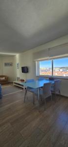 a living room with a blue table and chairs at Casa Mar in Costa da Caparica