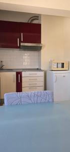a kitchen with a refrigerator and a counter top at Casa Mar in Costa da Caparica +15 photos