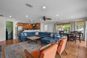 a living room with a blue couch and a table at Flip Side Oasis Beach House in Pensacola Beach
