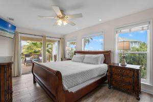 a bedroom with a bed and a ceiling fan at Flip Side Oasis Beach House in Pensacola Beach